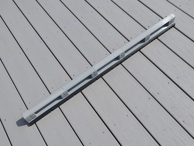 Close-up of Deck Board Spacer showing adjustable spacing settings for 1/8-inch, 1/4-inch, and 1/2-inch deck board gaps