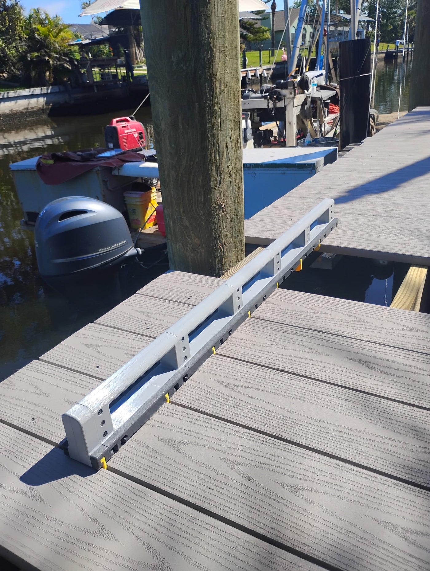 Deck Board Spacer maintaining proper alignment while a deck board is skipped for a cut around a railing post