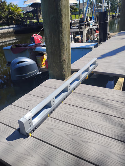 Deck Board Spacer maintaining proper alignment while a deck board is skipped for a cut around a railing post
